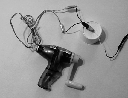 Figure 2: Generator connected to light, with sensor embedded in clay Figure 2: Generator connected to light, with sensor embedded in clay