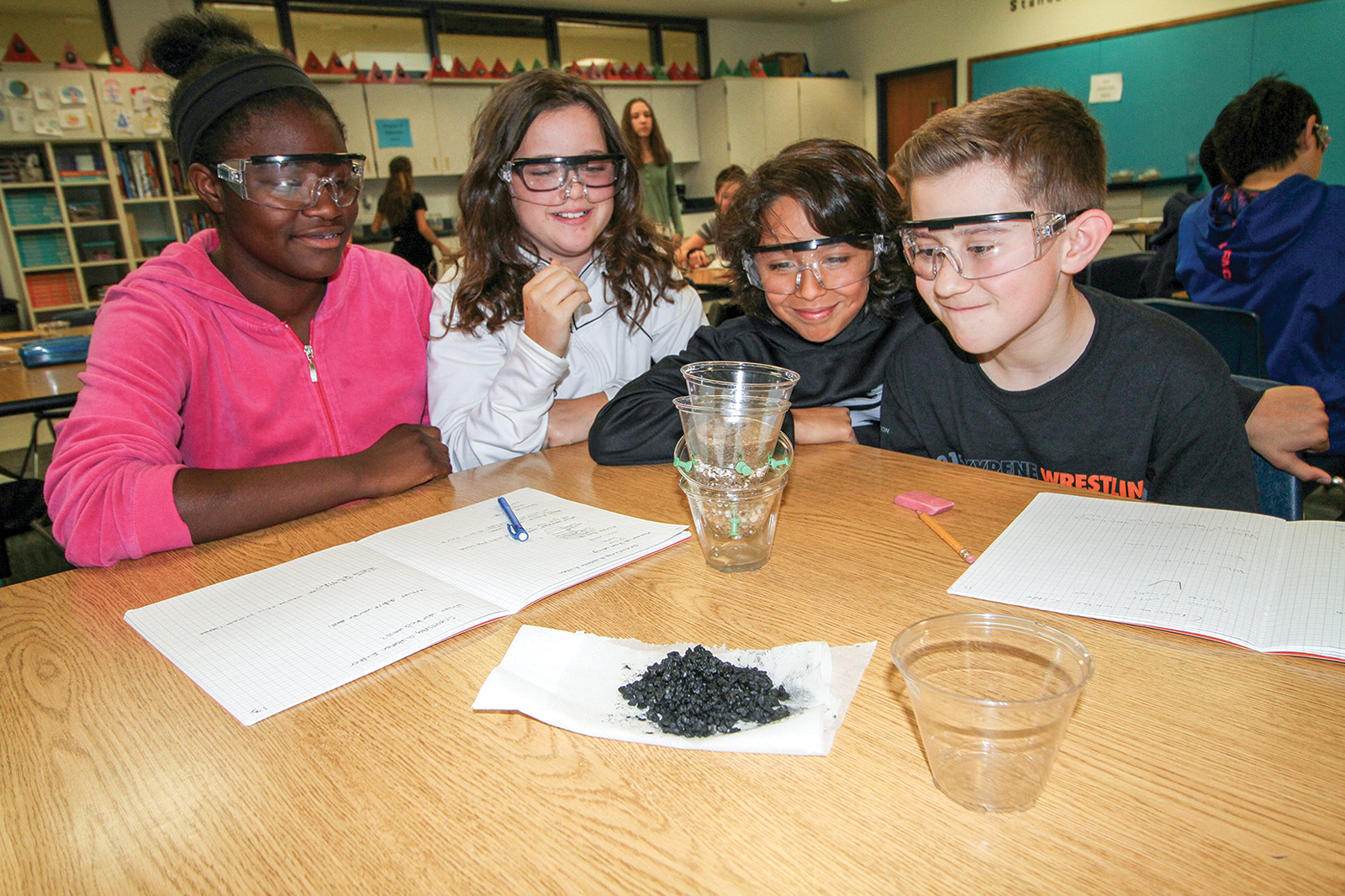 Students experimenting with filtering water