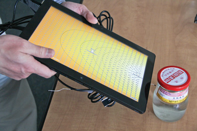 Figure 5. Frame prototypes built around our Energy2D simulator. (a) A tablet thermal imager near a jar of hot water.