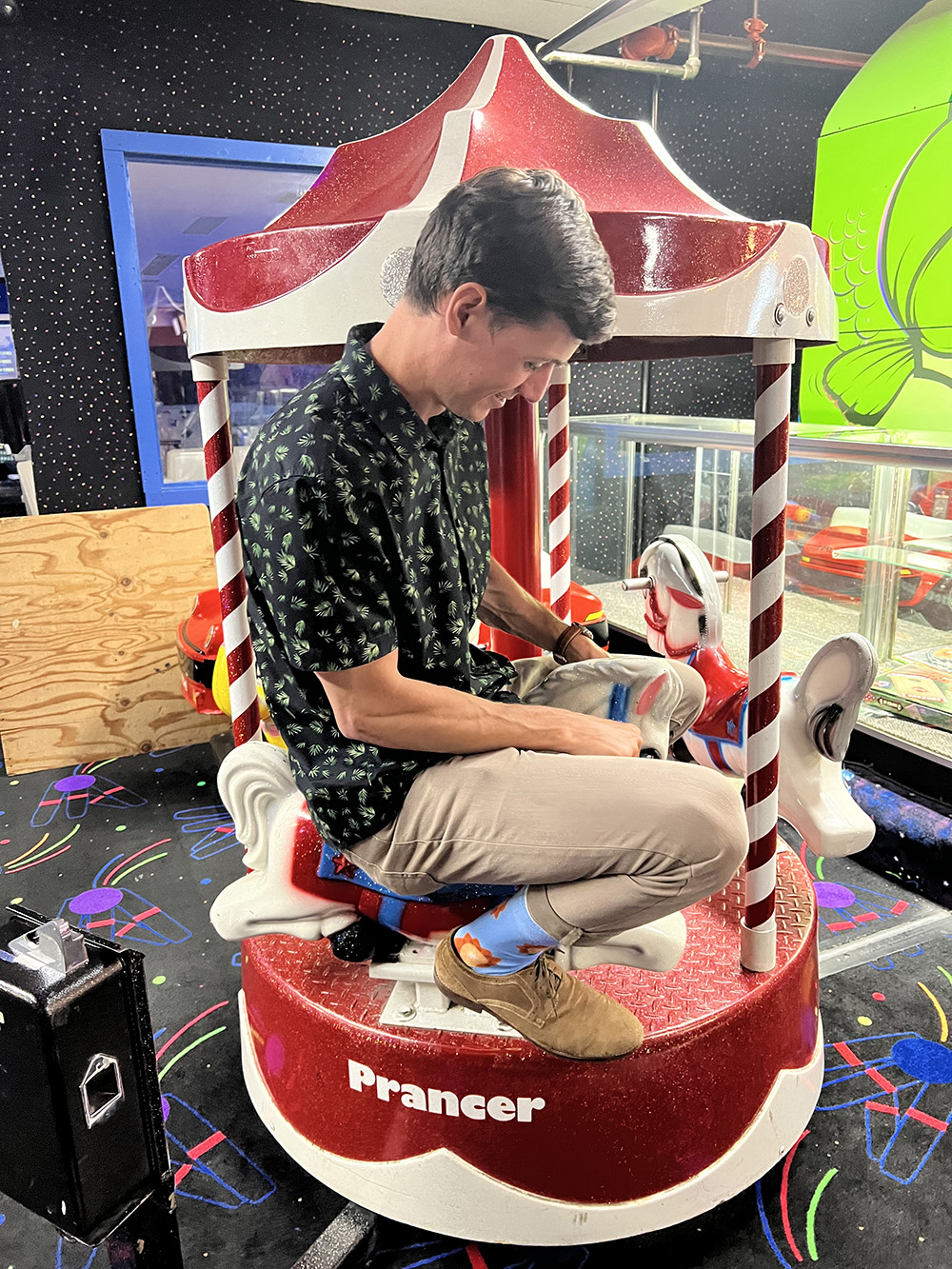 Sitting on a small arcade ride