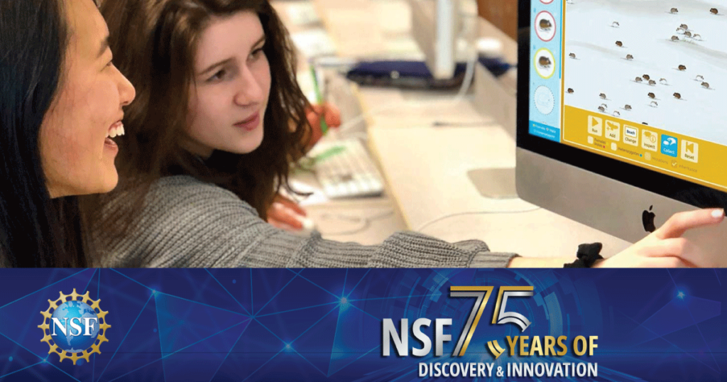 Two students at a computer with NSF 75th banner on top