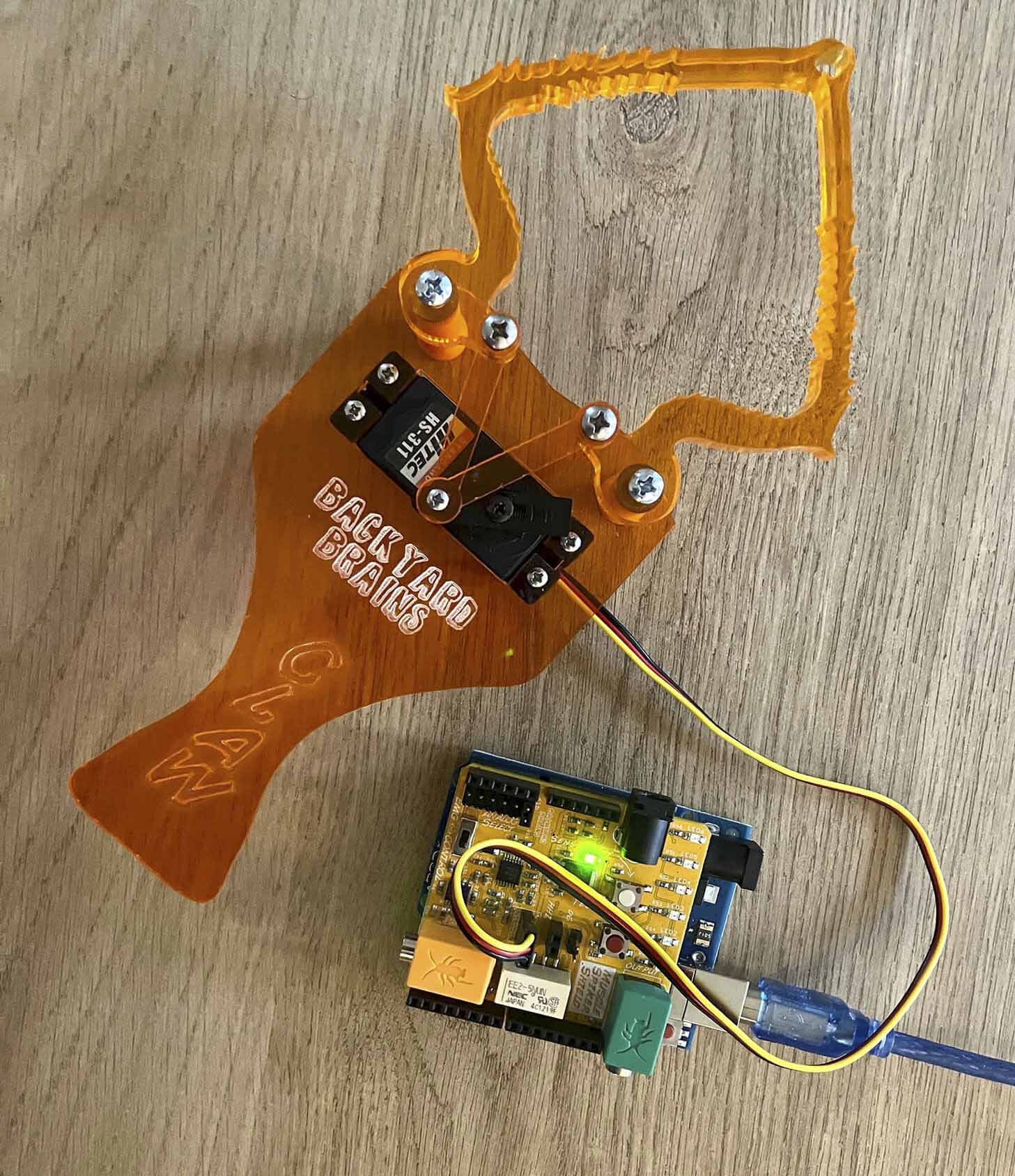 The Backyard Brains Claw and Muscle Spiker connect to an Arduino microcontroller.