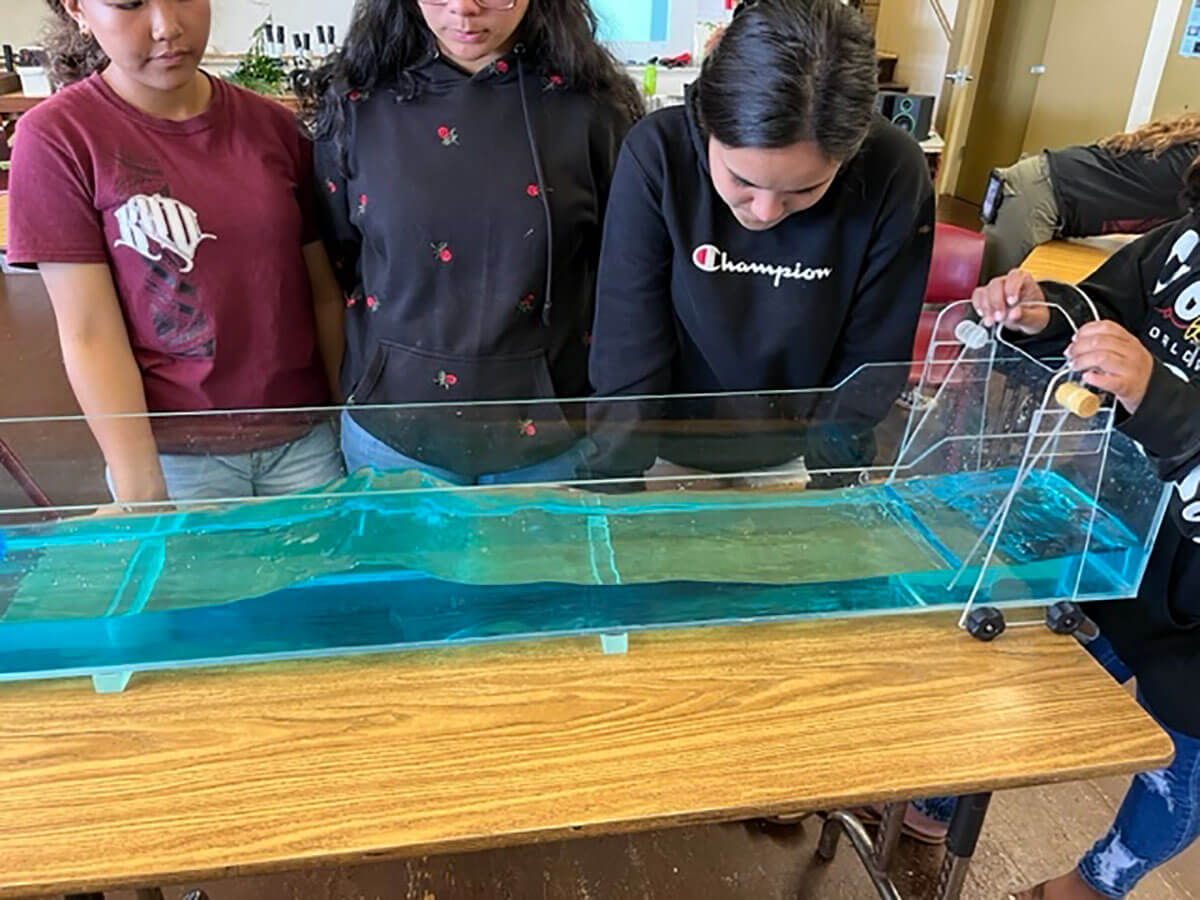 Creating a standing wave in a wave tank to understand a natural phenomenon in the ocean.